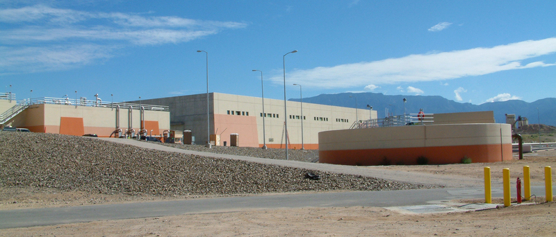 Industrial water treatment facility with multiple filtration tanks and pipes, showing a real-world water treatment plant infrastructure