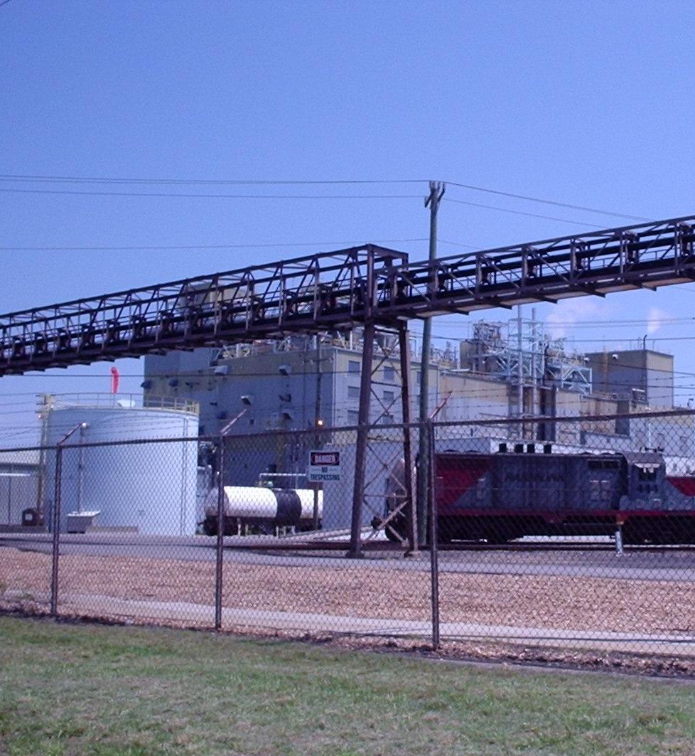 Large-scale chemical plant showing reactor vessels and distillation columns for industrial fine chemical production