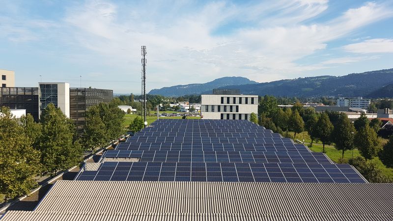 Photovoltaic solar panel installation on factory rooftop for renewable energy power generation