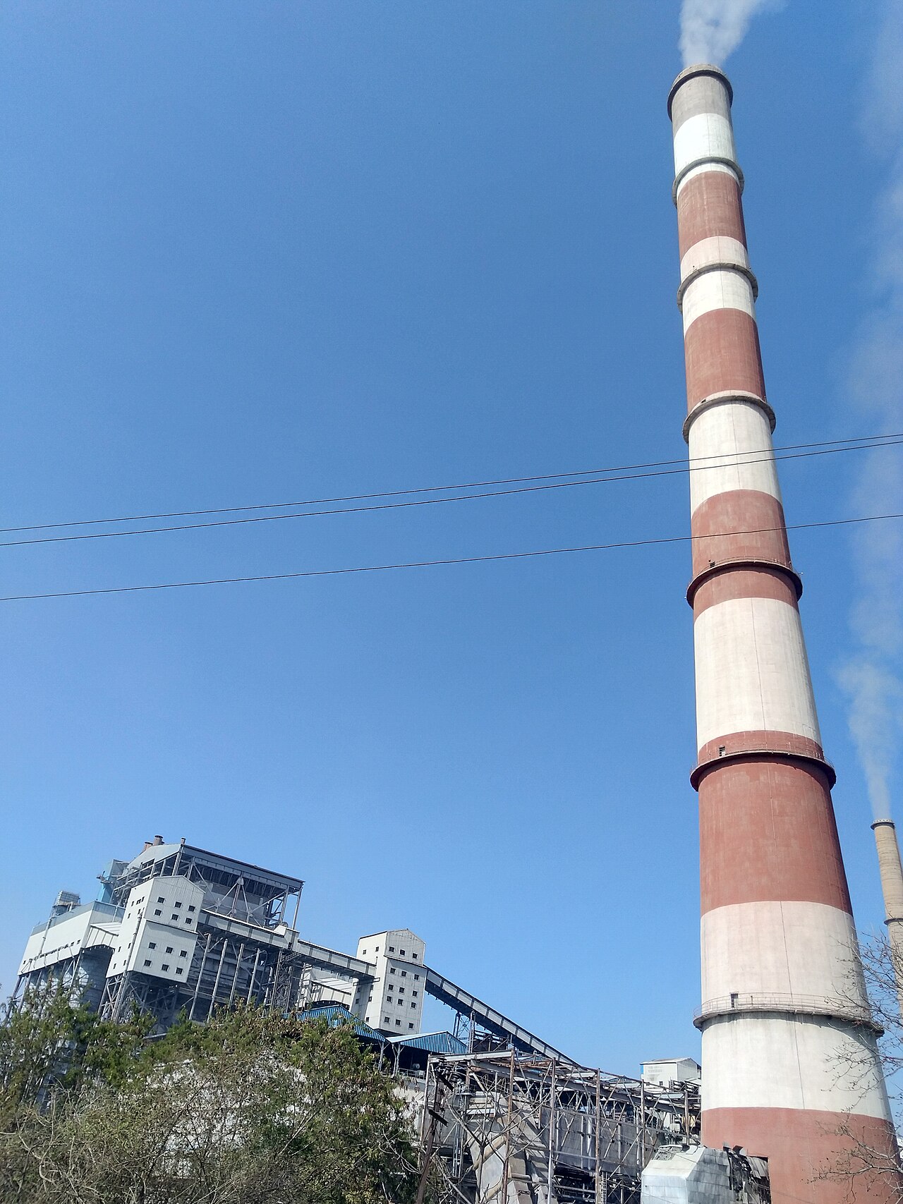 Thermal power plant chimney and boiler unit exterior view, illustrating the high pressure boiler feedwater system context for RO selection